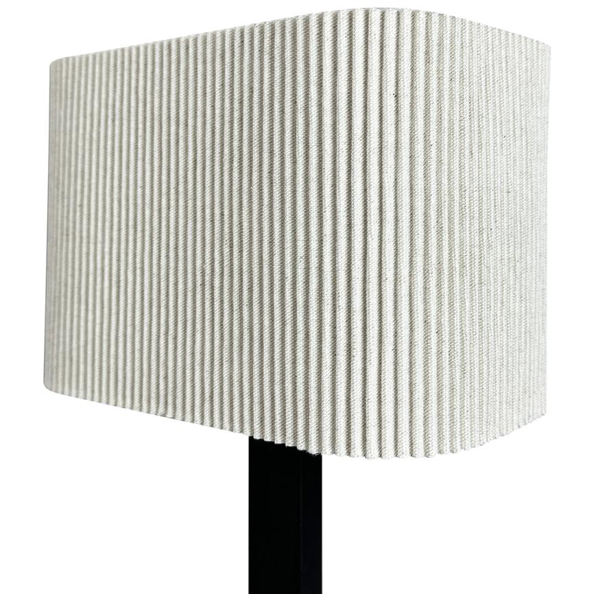 A ribbed light beige rectangular lampshade sits on a black lamppost; it has dense, vertical folds and stands against a neutral white background.