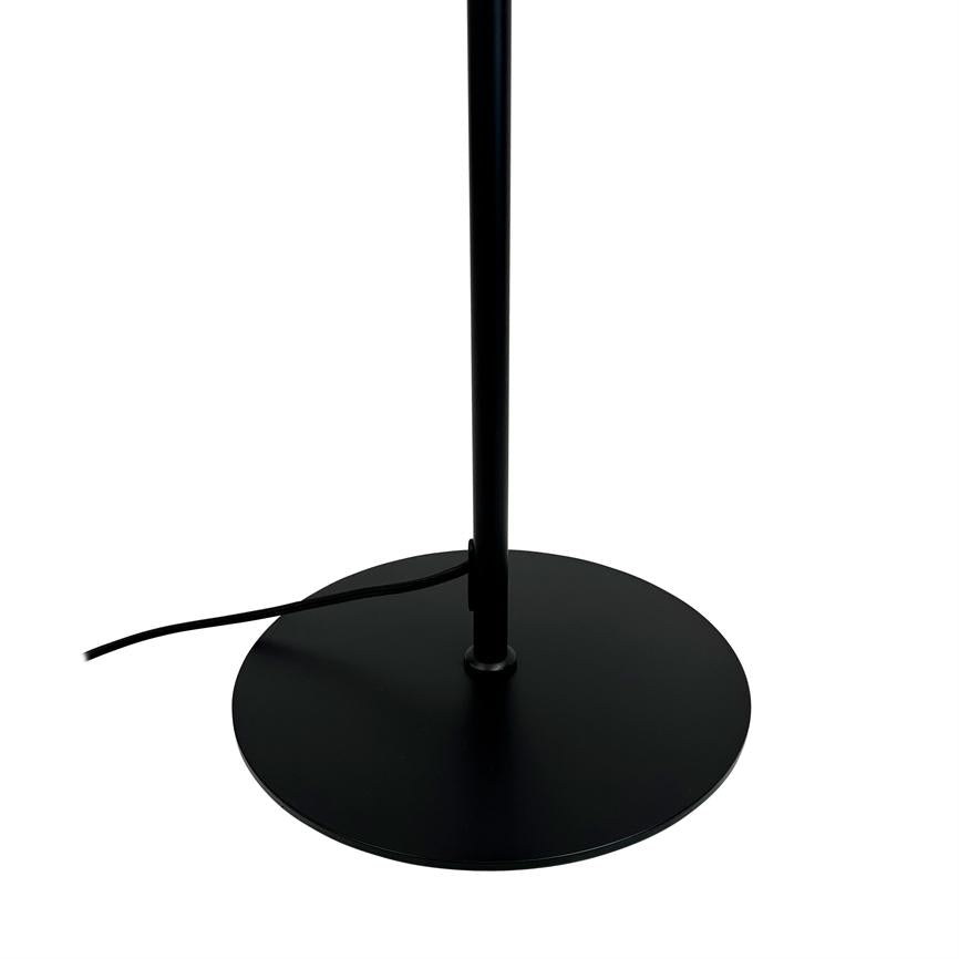 Black metal lamppost stands upright in the center of a flat, round base; a black wire runs out to the left on a white background.