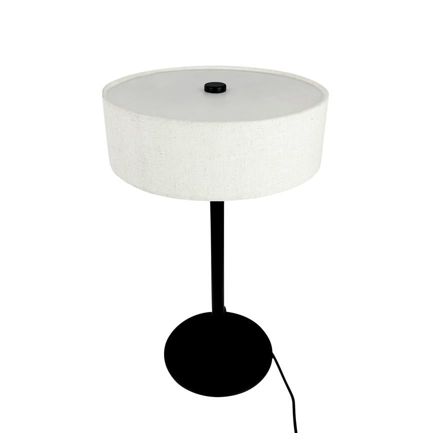 Table lamp stands on a round base; black narrow stand and white, cylindrical fabric shade; power cable runs out from the base; placed against a uniform white background.