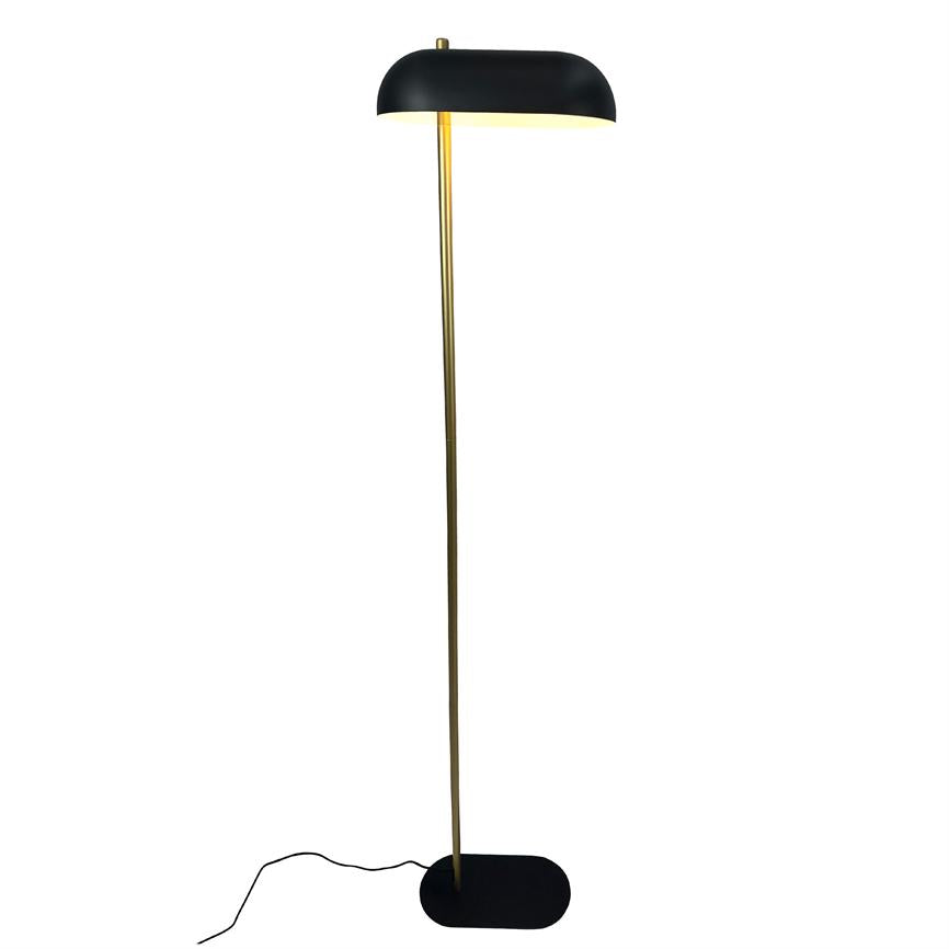 Floor lamp with black curved shade and slender brass rod stands on, casting soft light downwards; black oval foot and cord on a neutral white background.