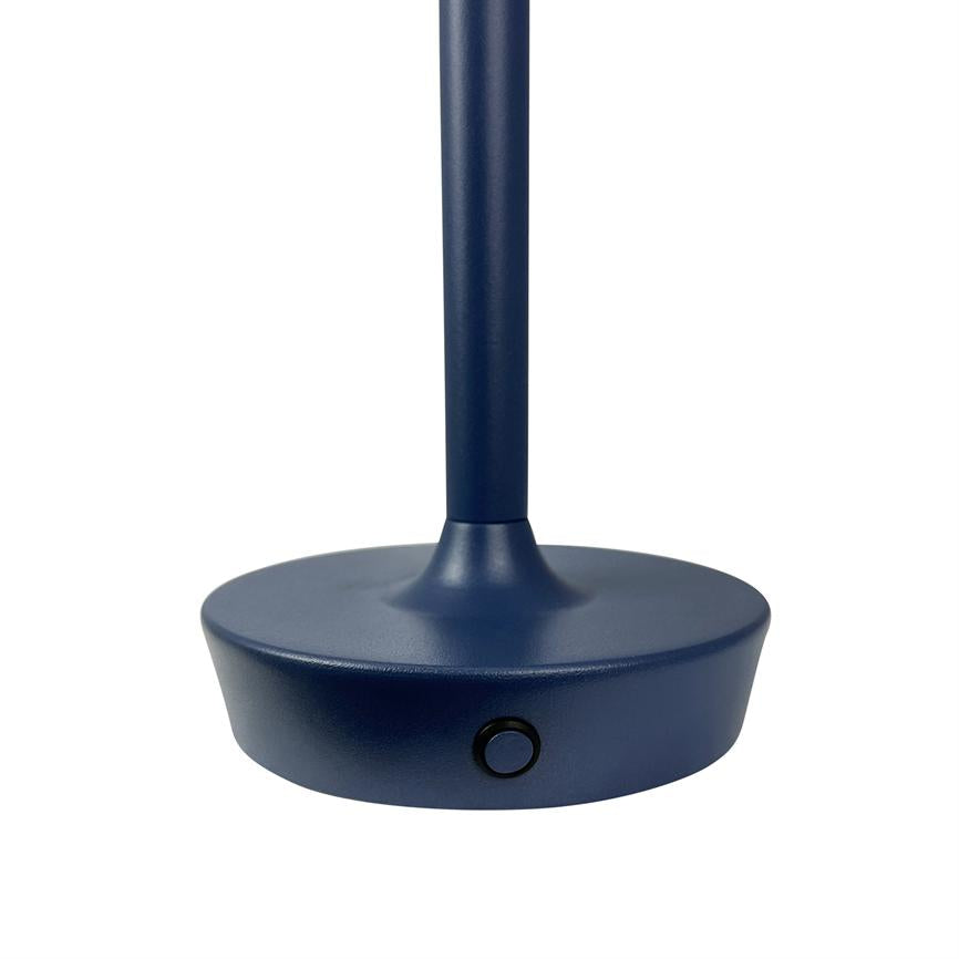 Dark blue round lamp base with visible push button holding a slender vertical rod; the whole unit stands against a simple white background.