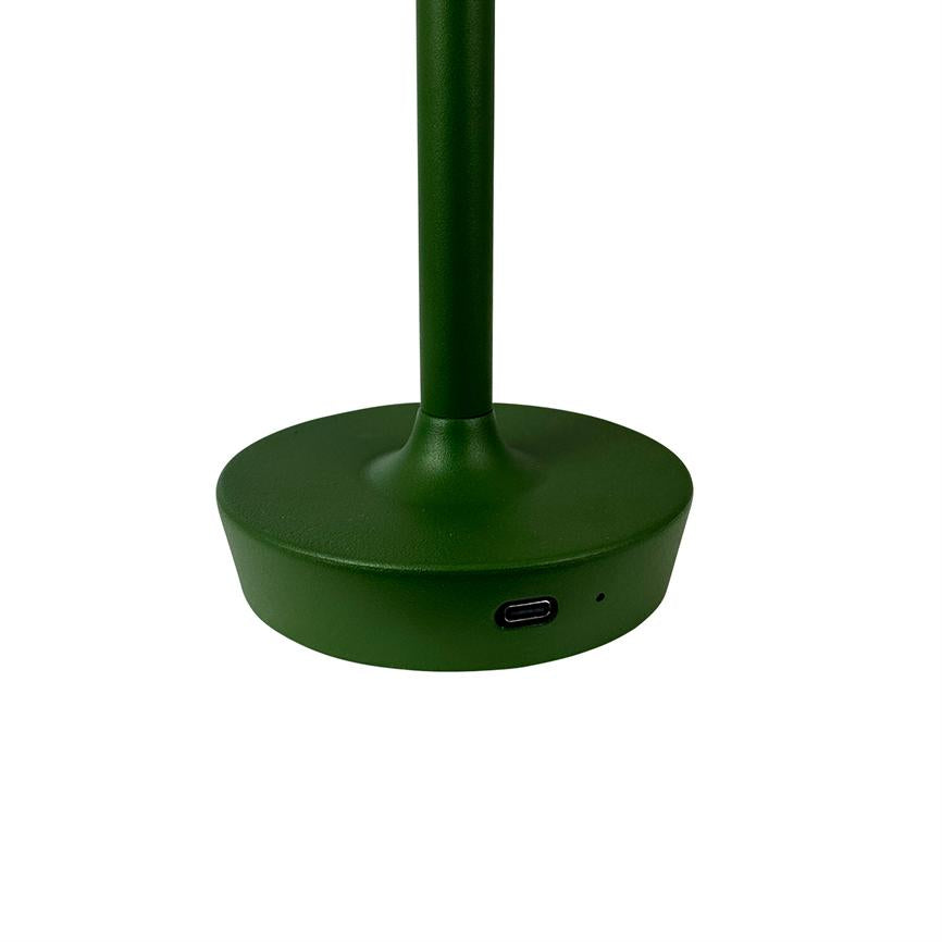 Green lamp base stands vertically; it has a visible USB-C port on the front. Round metal base placed isolated on white background.