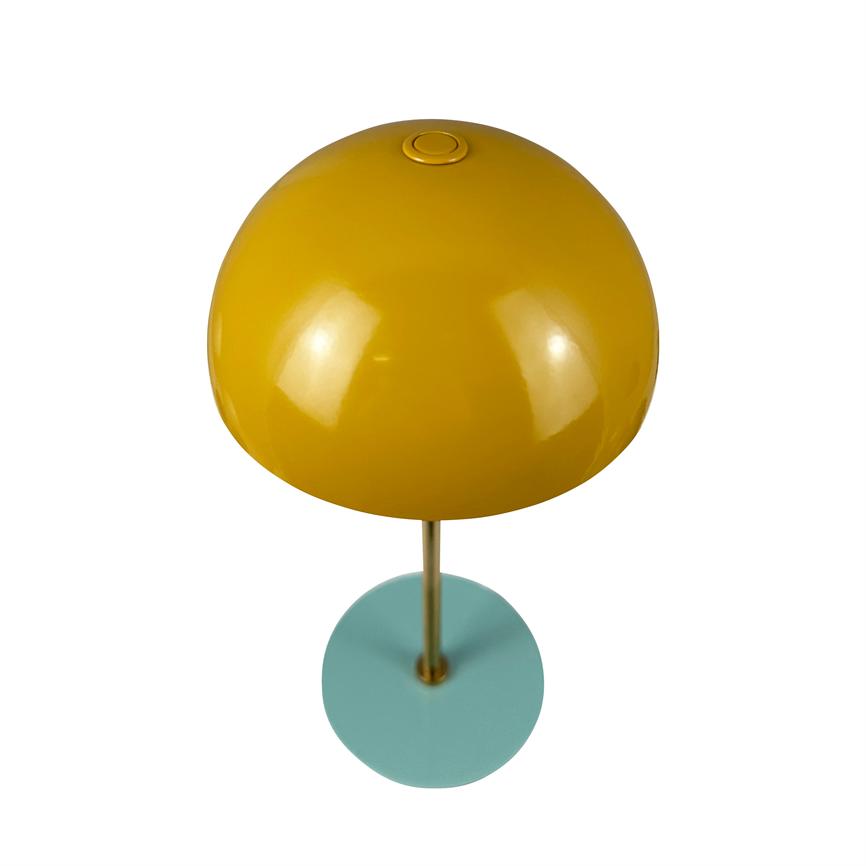 Yellow dome lamp with push button at the top rests on a thin gold colored stem and is mounted on a turquoise round base; glossy surface, white background.