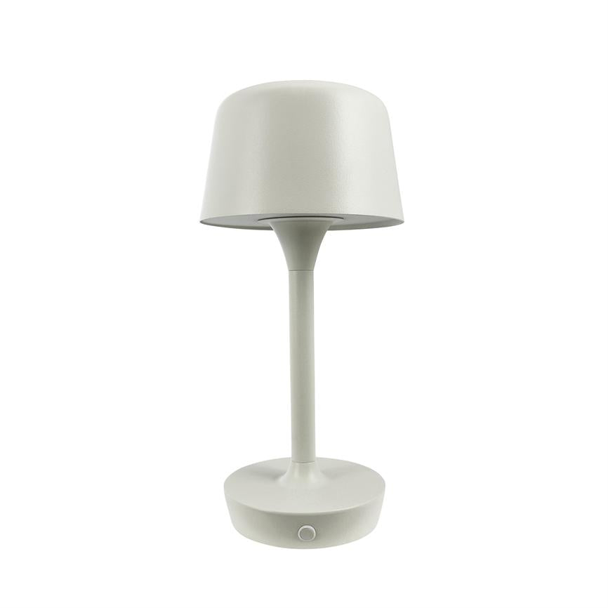 A white table lamp stands upright with a rounded shade and slender shaft; round base with small circular push button, set against a uniform white background.