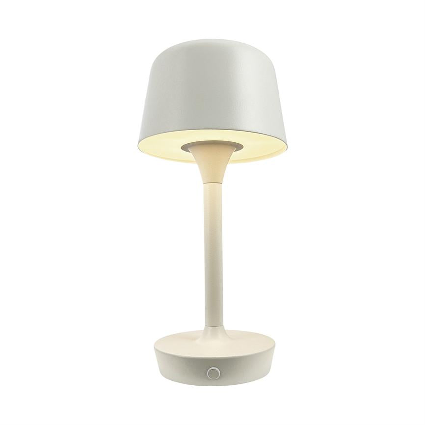 Table lamp emits soft, warm downward light; slender bar connects round foot and cylindrical screen; minimalist cream white design against neutral white background.