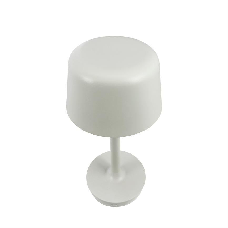 Table lamp stands on a white background, seen slightly from above; cylindrical shade, slim stem and round base with matte white finish.