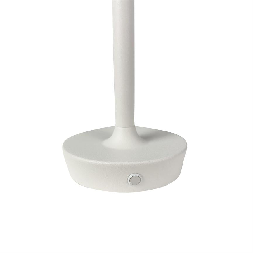 The lamp base is stable; a slender column rises from a round, matte white base with a small circular push button in front. The background is uniformly white.
