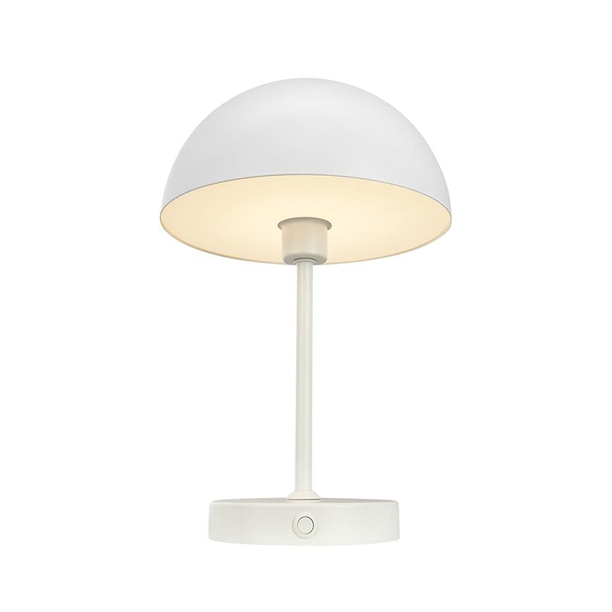 White table lamp with hemispherical shade, slim rod and round foot with button; the screen is on, casting soft, warm light against a neutral white background.