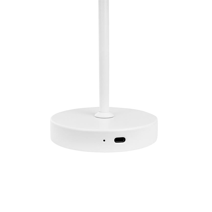 A round white lamp base stands with a vertical pole and houses a USB‑C port as well as a small indicator hole; surrounded by a uniform white background in a minimalist product photo.