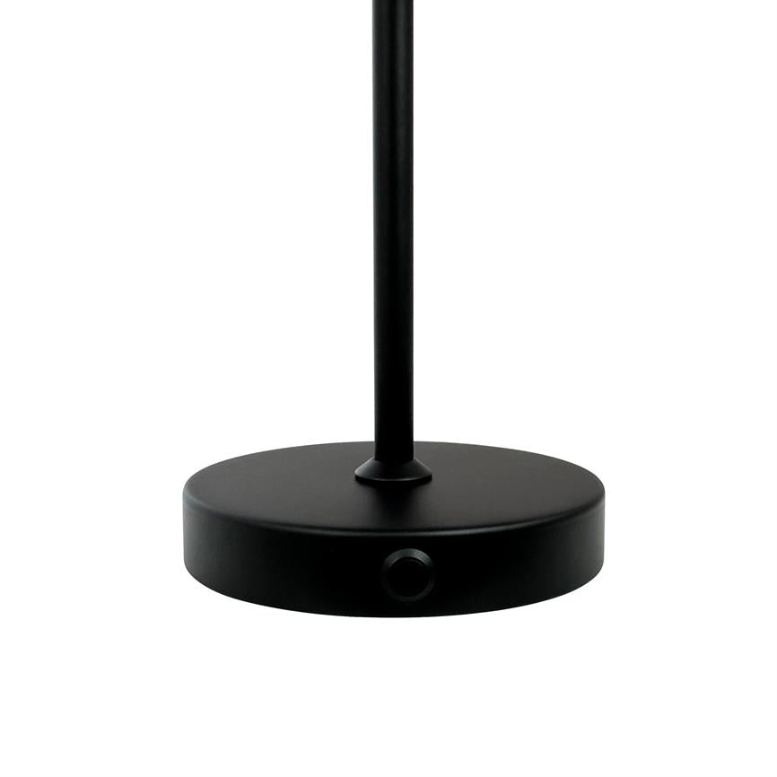 A black, round lamp base carries a slender vertical rod; a small circular button is recessed into the edge of the foot. Isolated on white background.