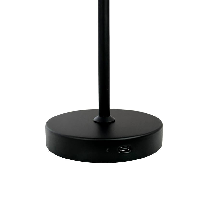 Black, round lamp base supports a thin, vertical rod; a USB-C port and small indicator sit on the side. Surroundings: uniform white background.