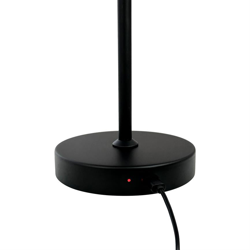 Black lamp base with upright pole, showing a lit red diode and a connected power cable, set against a uniform white background.