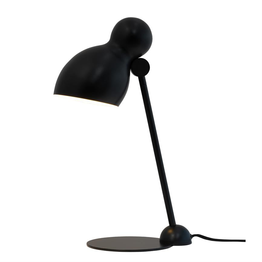 Black desk lamp tilts forward and casts light downwards; slender sloping arm and round shade mounted on flat, circular base against a pure white background.