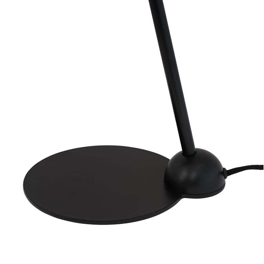 Black table lamp with flat, round foot and rounded base; a slender rod slopes upward from the plinth. Stands alone against a uniform, white background.