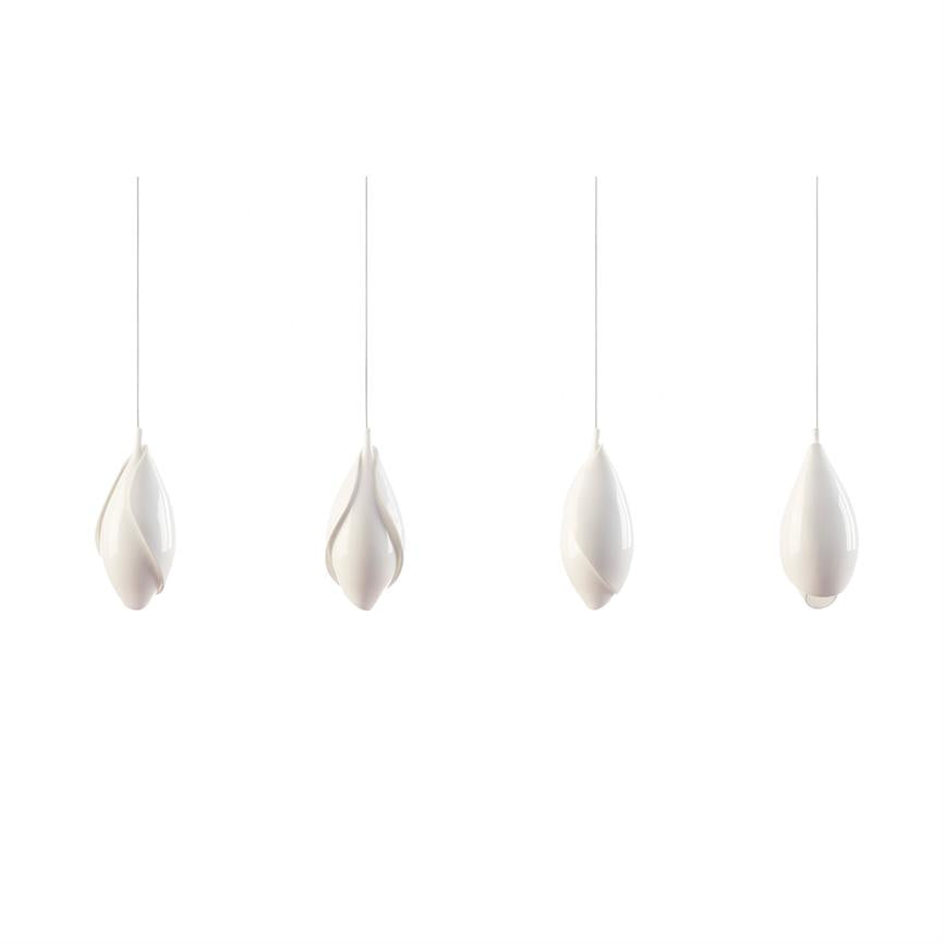 Four white, drop-shaped pendant lamps hang from thin links, each with soft pleats; they float in a bright, empty space against a uniform white background.