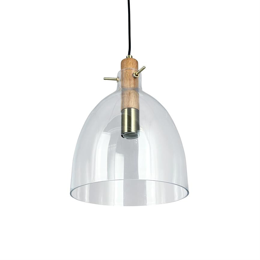 A pendant lamp hangs from a black cord; clear, domed glass shade encloses a brass socket and wood detail; background is uniformly white, lamp seen from the front.