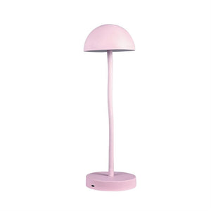 Pink table lamp stands with a curved, slender rod and hemispherical shade above a round base on a white background.