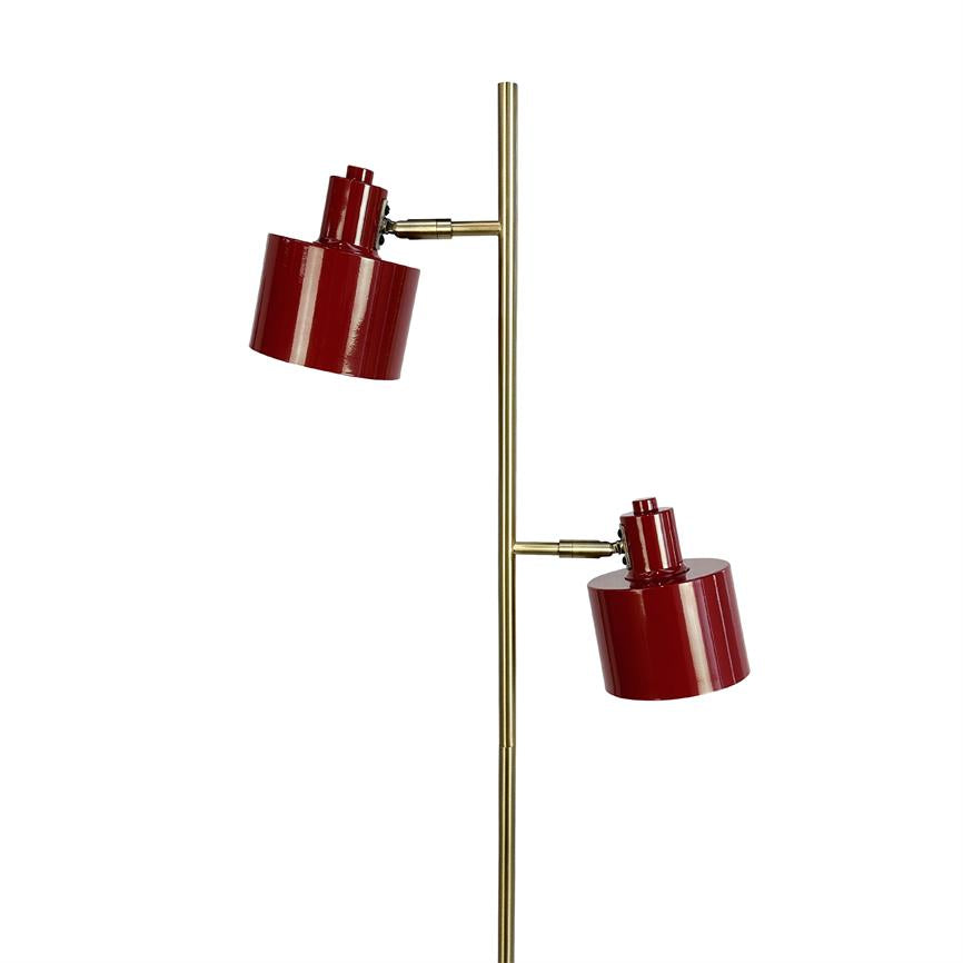 Floor lamp with two red, glossy shades mounted on adjustable arms along a slender gold-coloured vertical rod in front of a white background.