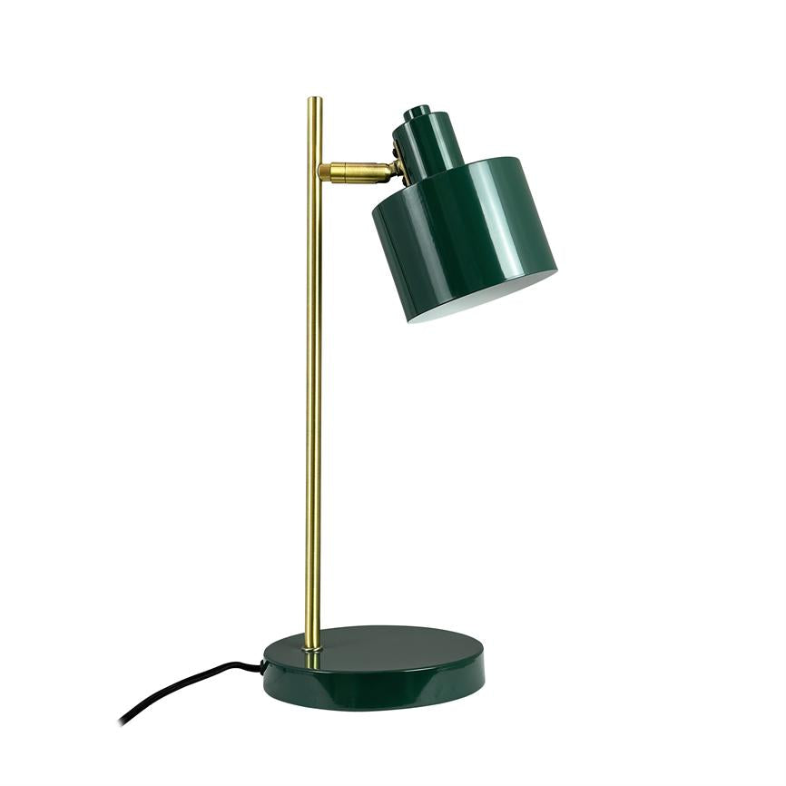 Green metal table lamp with brass rod stands on a round base; lampshade is angled downwards like a desk lamp, with black cord lying to the left on a white, uniform background.