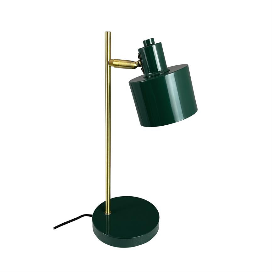 Green desk lamp with cylindrical shade; the screen is angled obliquely downwards, mounted on a golden vertical stand and round green base with black cord, against a pure white background.