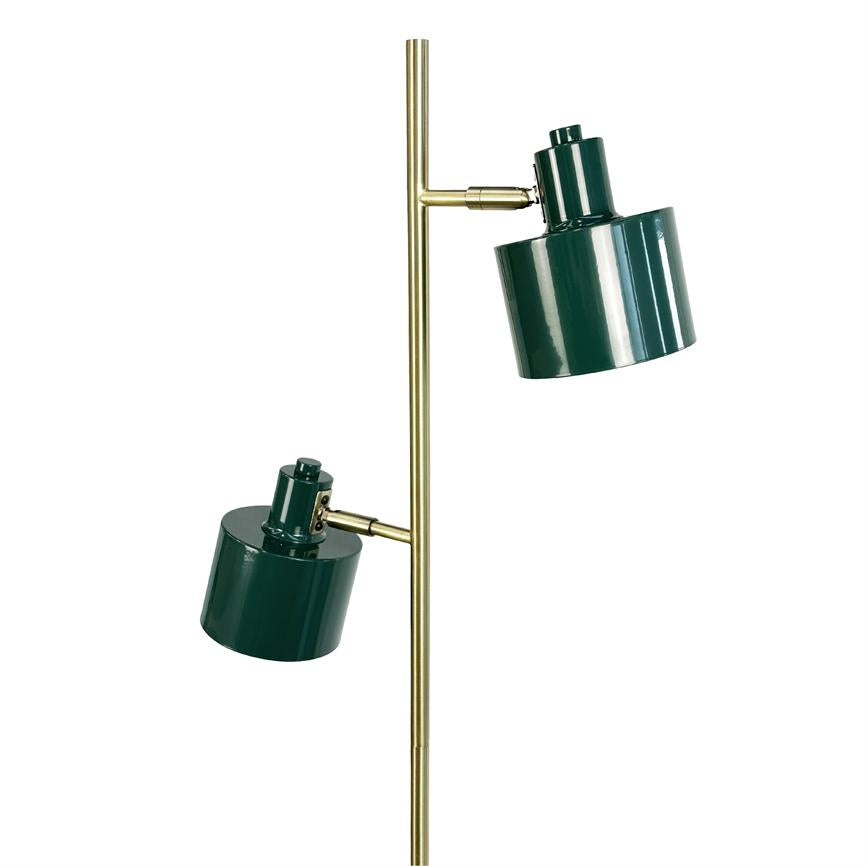 A floor lamp with two green cylindrical shades mounted on a slender brass rod; the screens are tilted at different angles against a white background.