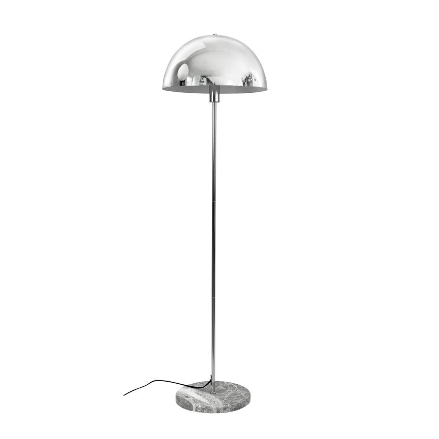 A chrome floor lamp with hemispherical shade stands on a slim rod and round marble base; black wire lies loosely on white background in an empty bright environment.