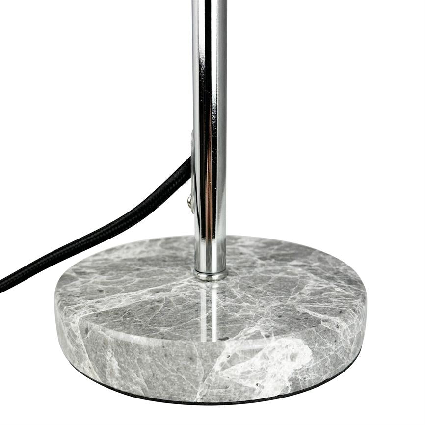 Round marble lamp base supports a vertical chrome rod; a black, cloth-covered wire runs along the pole, photographed close-up against a uniform white background.