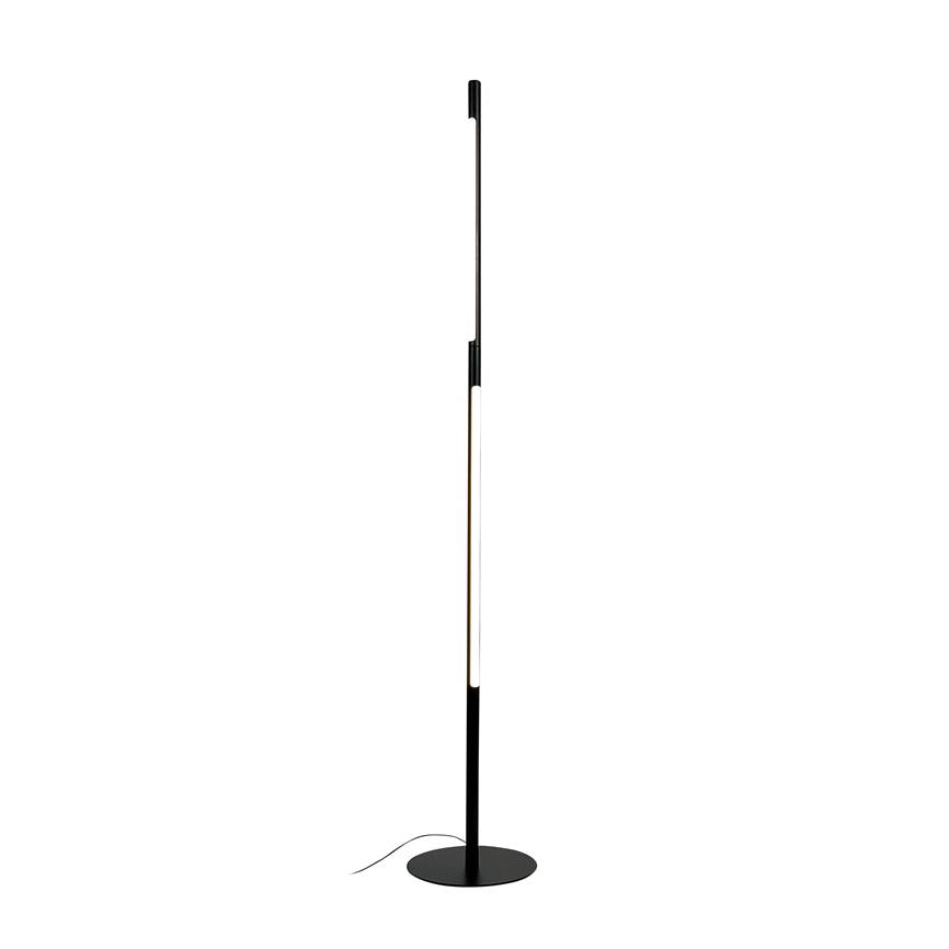 A slim, black floor lamp illuminates with a vertical LED strip and stands on a round metal base in front of a uniform white background.