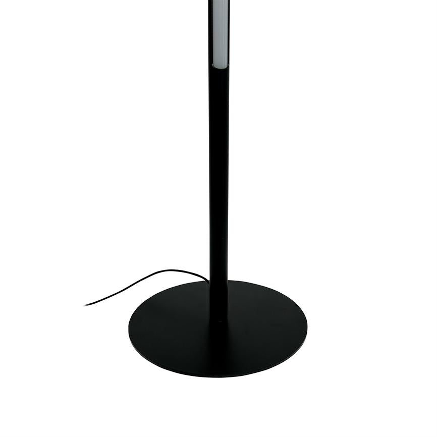 Floor lamp: a slim, black stand stands vertically; round base plate rests on a white background, and a thin black power cable runs out to the side.