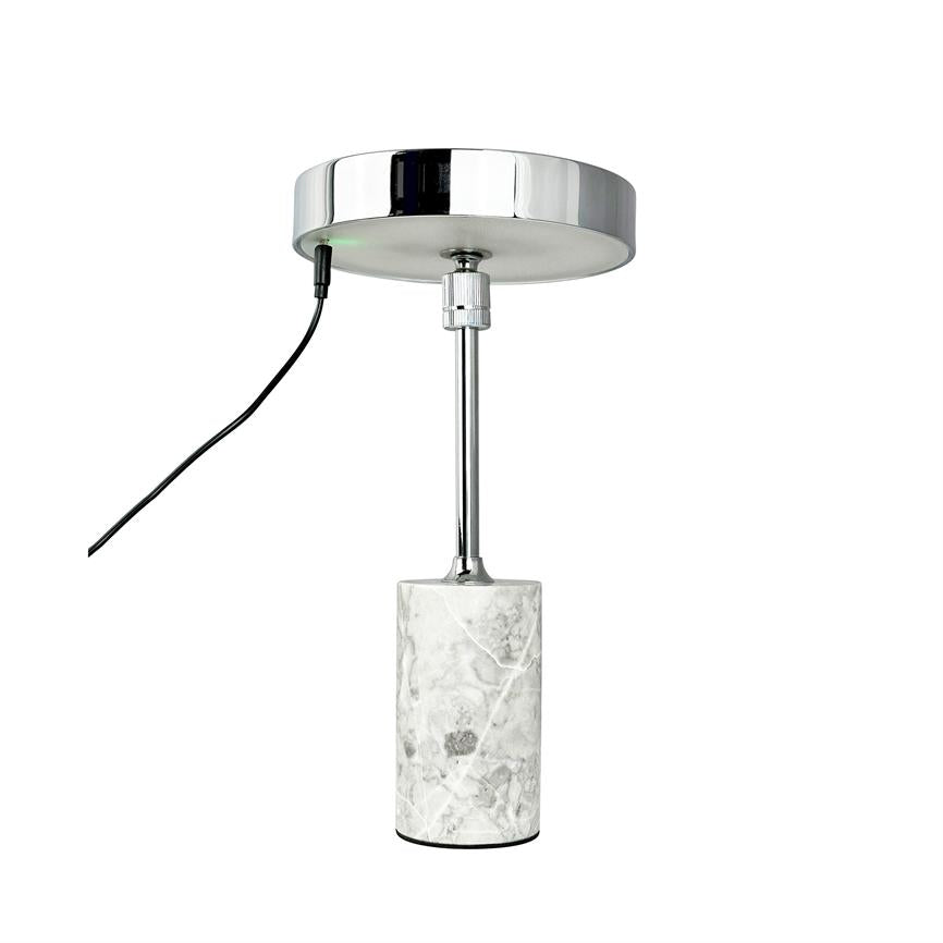A pendant lamp pendant hangs — a chrome round ceiling rose, slim metal rod and cylindrical white marble weight; a black wire runs out to the left on a uniform white background.