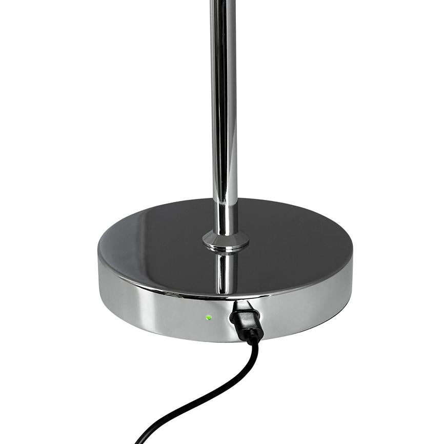 The lamp's chrome base has a cable attached to the side; a green LED lights up while the lamp shaft extends upwards against a white background.