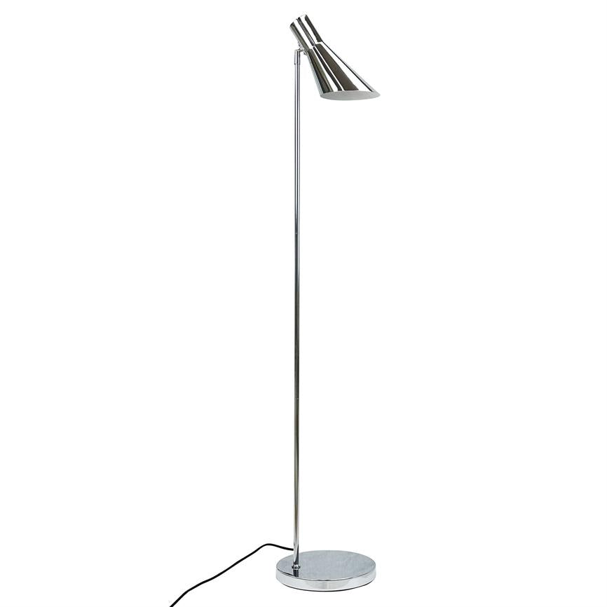 A tall chrome floor lamp stands with a slender rod, round base and an angled, cone-shaped lamp head directed downwards; black cord lies loosely at the foot on a white background.