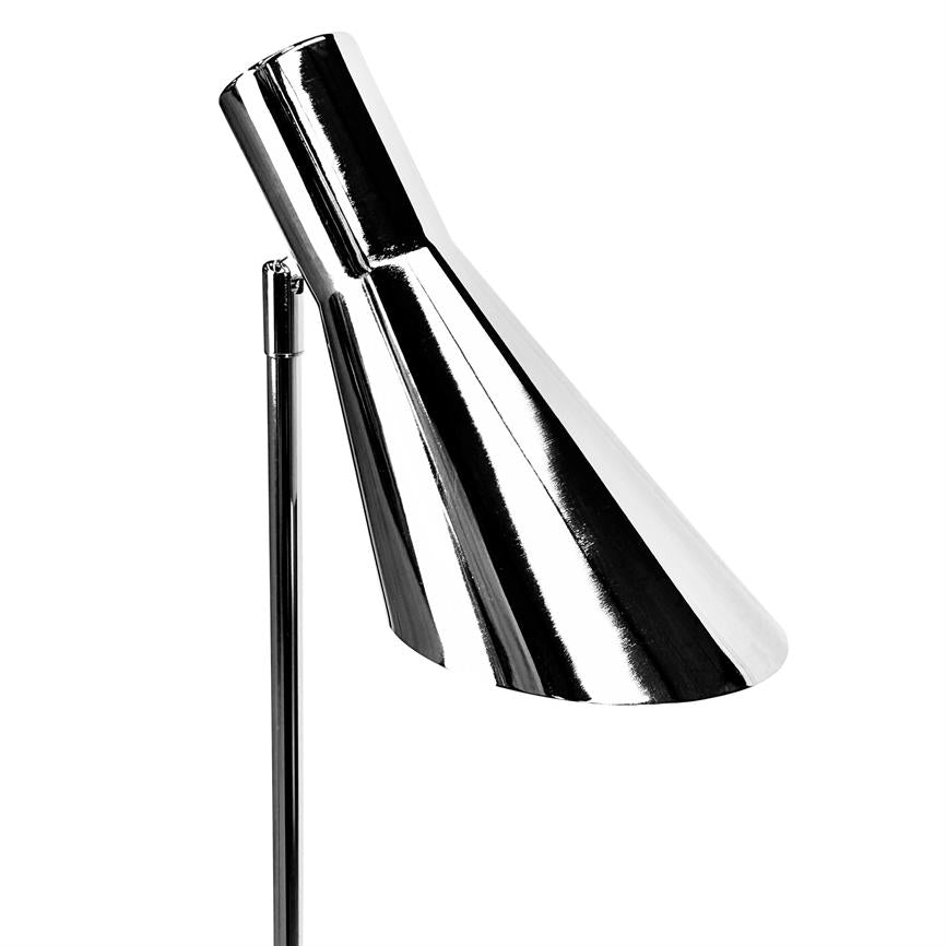 Chrome desk lamp points obliquely downwards; slim, adjustable lamp head mounted on a thin rod in front of a uniform white background, polished and mirrored.