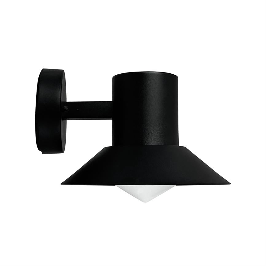 A black metal wall lamp mounted on a round wall plate; a short arm leads to a cylindrical plinth and a wide screen that points downwards above a white pyramidal diffuser.