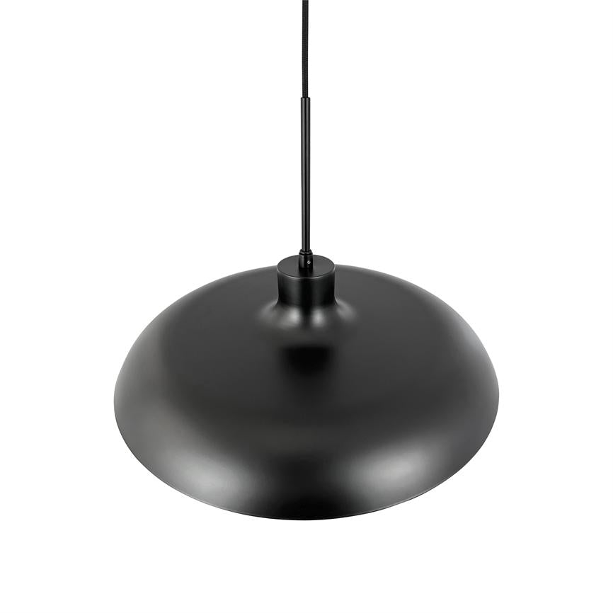 Black pendant lamp hangs by thin cord over white background; wide, bowl-shaped metal shade with matte finish, simple and modern design for ceiling lighting in minimalist space.
