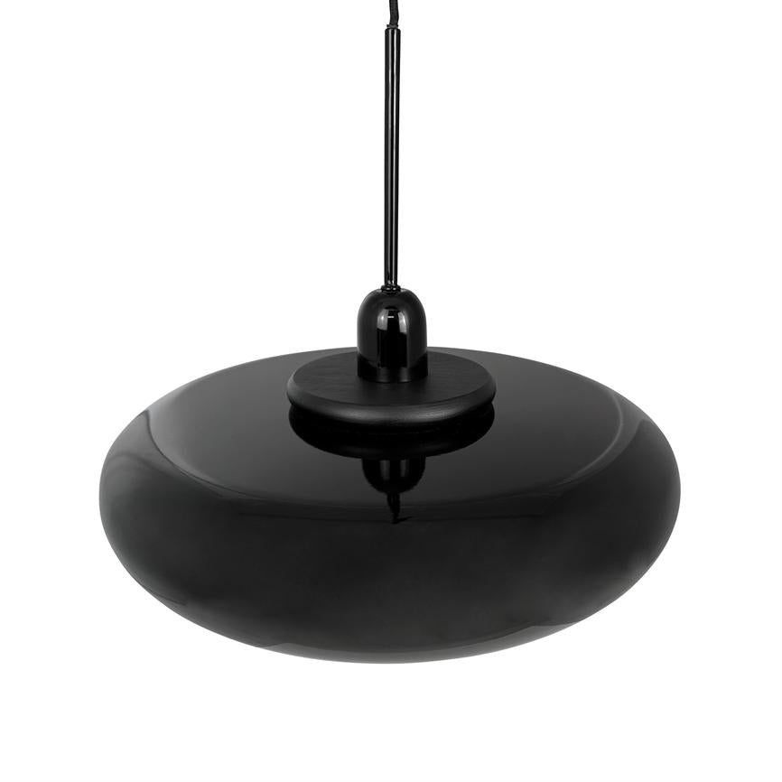 Black pendant-lamp hangs on a thin wire over white background; glossy, wide, low, round screen with gloss and soft reflections, in a minimalist studio setup.