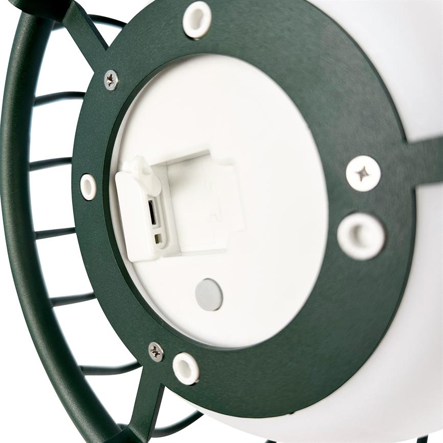 Round outdoor lamp with green metal frame, whose white battery cover is open to reveal a USB port; close-up view shows screws and mounting holes on white background.