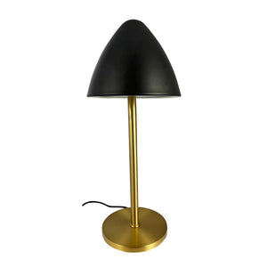 Black, mushroom-shaped lampshade stands on a slender, gold-colored rod with a round base; a black wire lies at the base on a white background.
