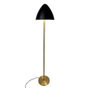 Floor lamp with black hemispherical shade, golden slim rod and round base; casts warm light downwards, with black cord on white neutral background.
