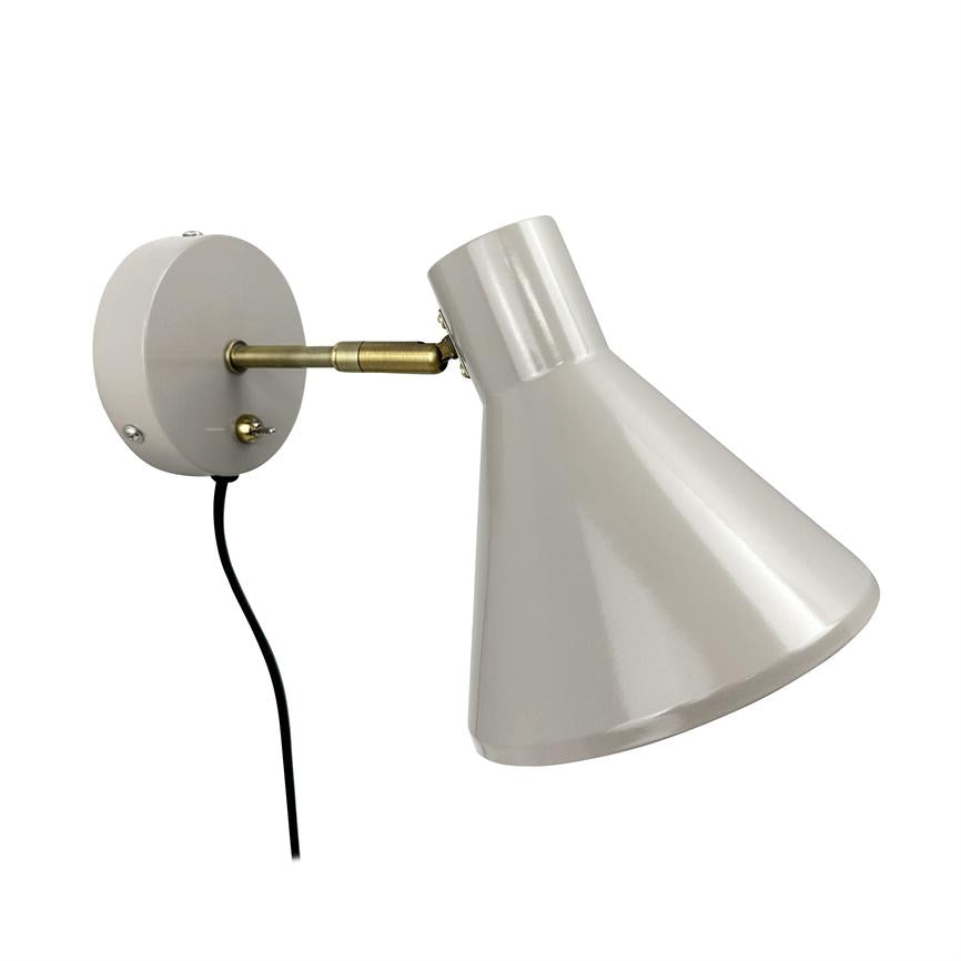 Wall lamp with cone-shaped metal shade, attached to round wall plate via a short brass arm; the screen is angled down and to the right, black wire hanging against a white background.