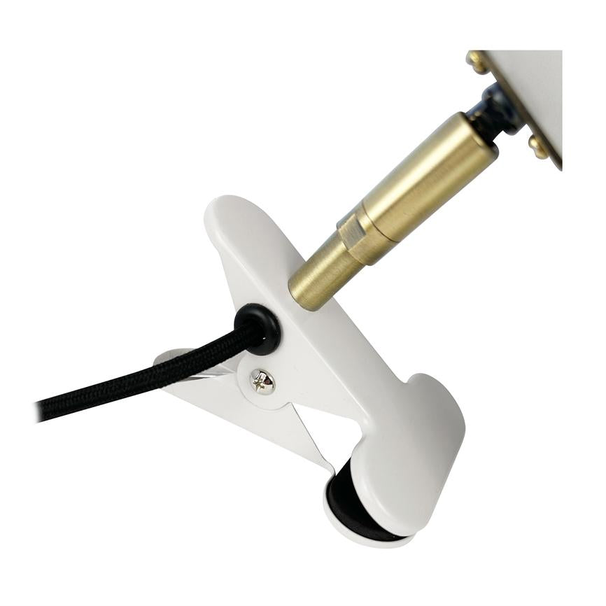 White clamp holds a black textile wire, connected to a brass colored header; the clip is open and attached to a lamp arm against a neutral white background.
