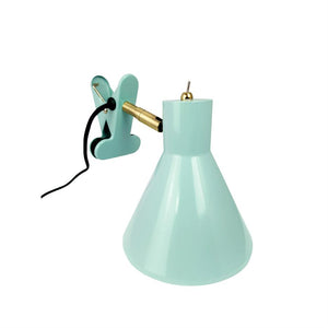 Mint green clamp lamp with conical shade, angled brass arm and black cord, designed to clamp onto an edge, photographed in front of white background.