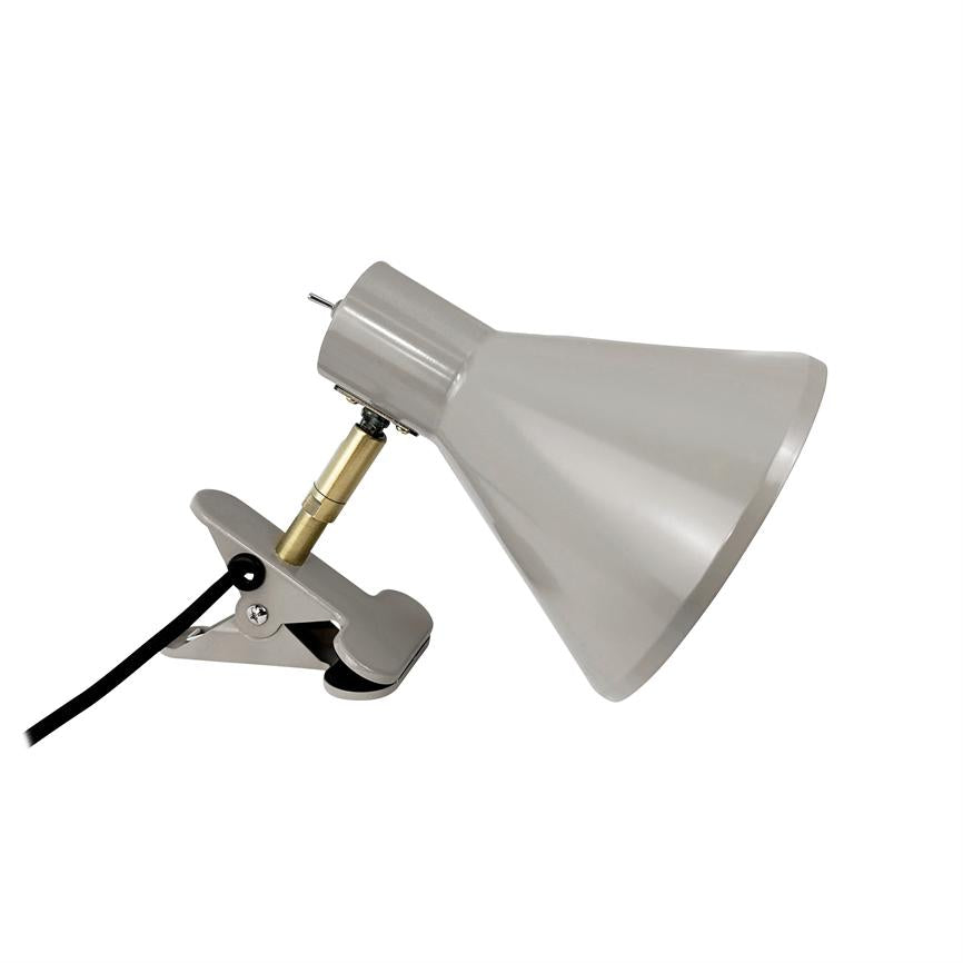 Clip-on lamp with cone-shaped shade, slants to the right and is attached to a metallic clamp via an adjustable brass link; black wire runs out to the left.
