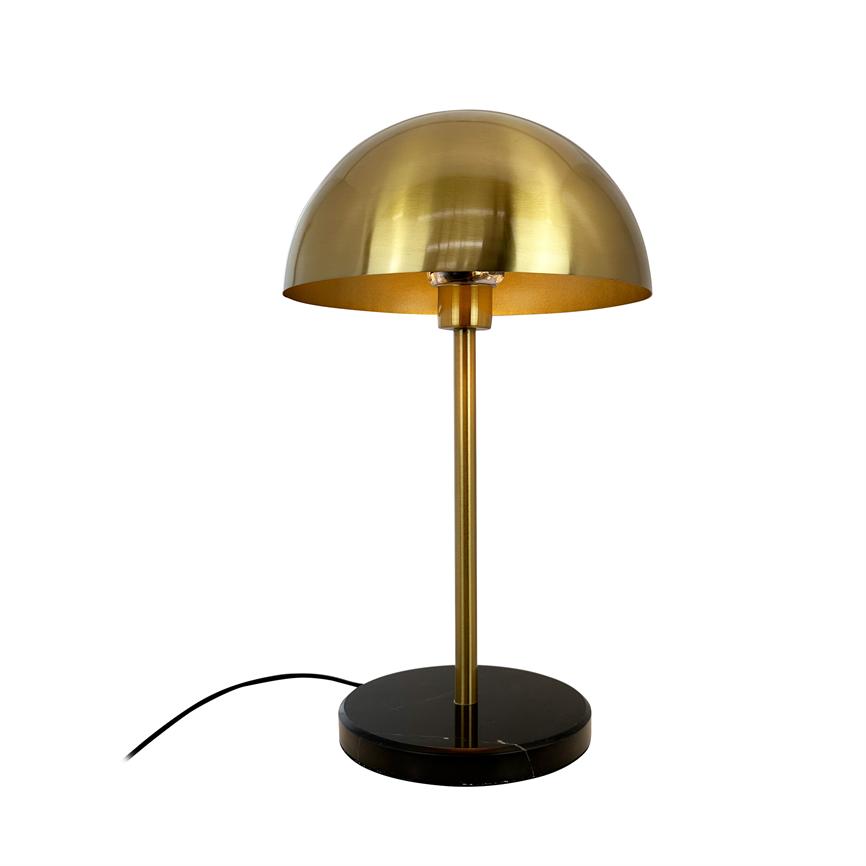 Gold-plated table lamp with hemispherical shade, stands on a slender rod and round black marble base; black wire lies at the foot; photographed against a white background.