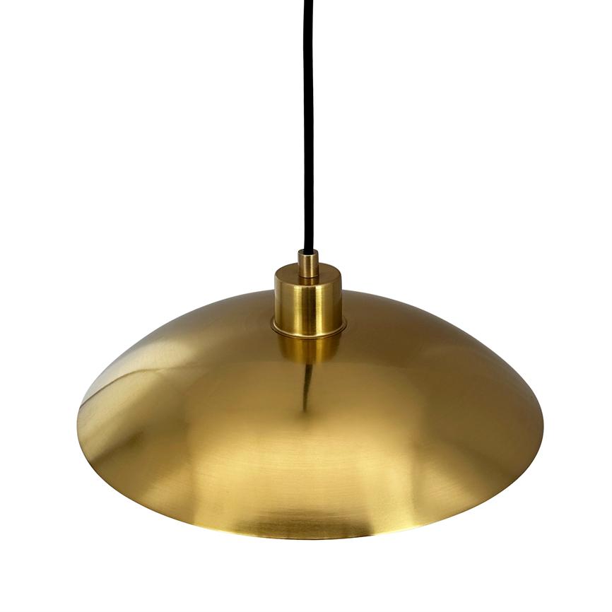 A round, brass-coloured pendant lamp hangs from a black cord; its wide, bowl-shaped metal shade reflects soft light and stands isolated against a neutral white background.