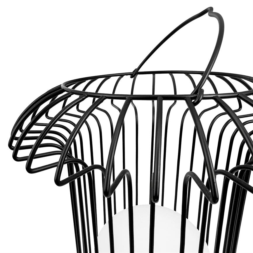 Black wire basket lamp hangs from a curved handle, its undulating metal rods encasing a round white bulb; close-up on a plain white background.