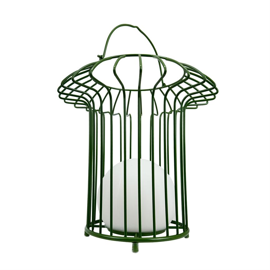 Green metal cage holds a white round lamp where thin vertical bars surround the bulb, with hanger on top, free standing against a pure white background.