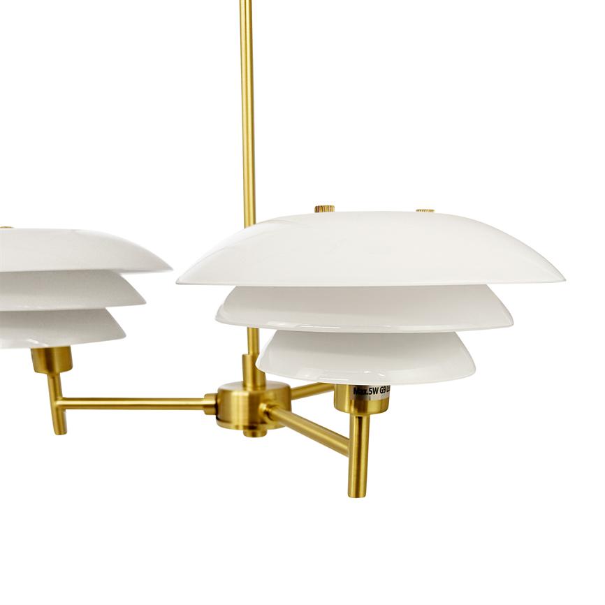 Hanging lamp hangs with three layered white shades, mounted on matte gold colored metal arms over a plain white background. Text: "Max.5W G9"