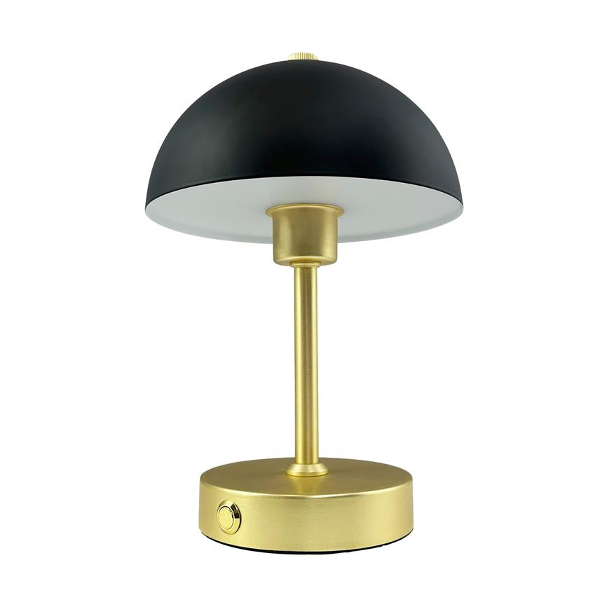 Table lamp with black hemispherical shade stands on a slim, gold-coloured column; the lamp shines downwards and rests on a round gold-coloured base with a small on/off button, against a white background.
