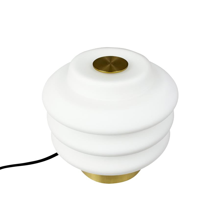 Bordlampe med rund, lagdelt hvid opal-glasskærm, messingdetaljer i top og bund og sort ledning; står på hvid baggrund i studieoptagelse.